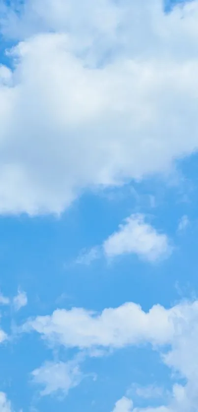 A serene blue sky with scattered fluffy white clouds.