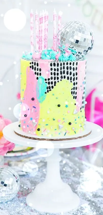 Colorful disco-themed birthday cake with candles on a stand.