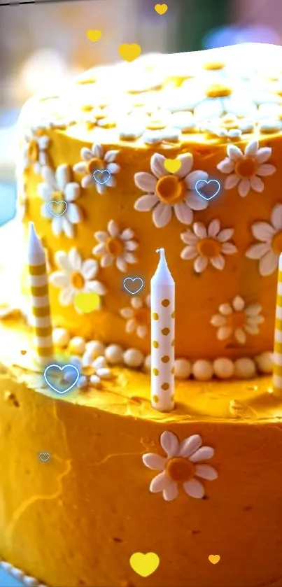 Yellow cake with floral design and candles on a mobile wallpaper.