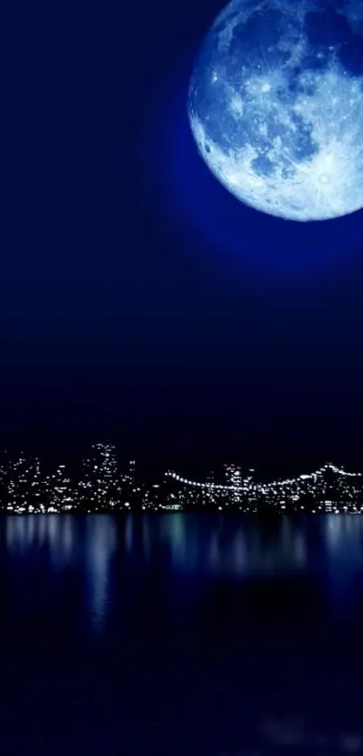 Full moon over a city with reflections on water, in dark blue hues.