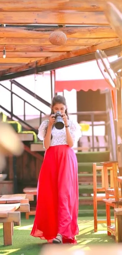 Woman in red skirt enjoys coffee at a sunlit outdoor cafe.