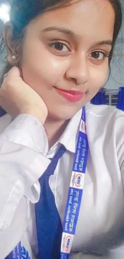 Student in bright school uniform smiling indoors.