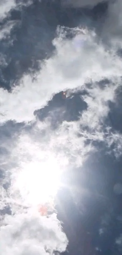 Bright blue sky with clouds and sun shining.