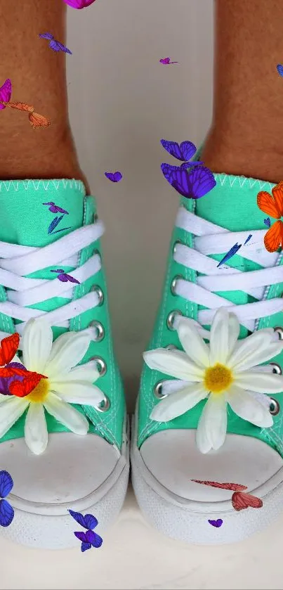 Turquoise sneakers with daisies and colorful butterflies decorating them.