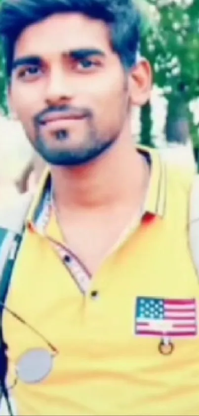 Young man in yellow shirt with sunglasses and backpack.