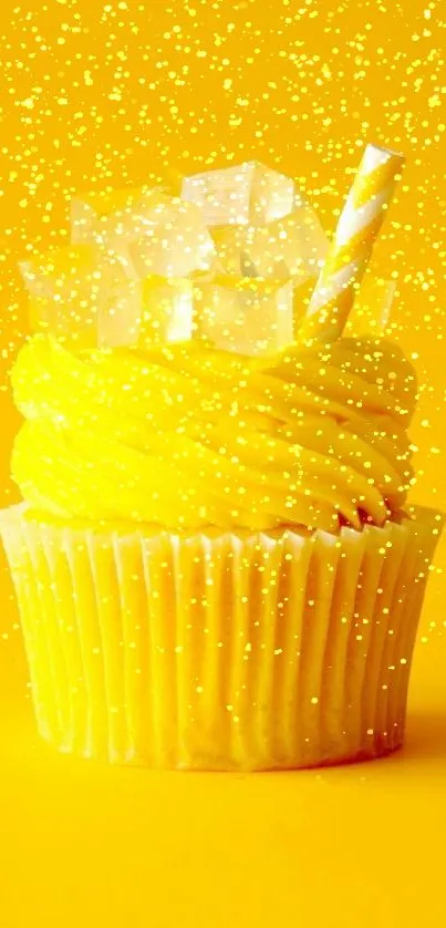 Bright yellow cupcake with straw and ice cubes on yellow background.