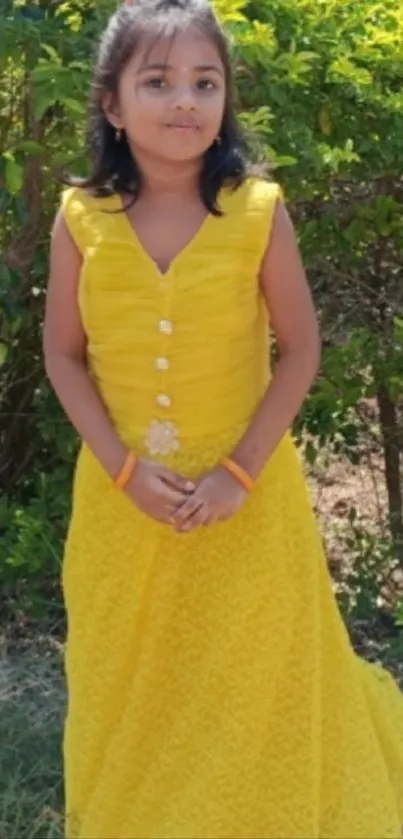 Young girl in a yellow dress standing outside
