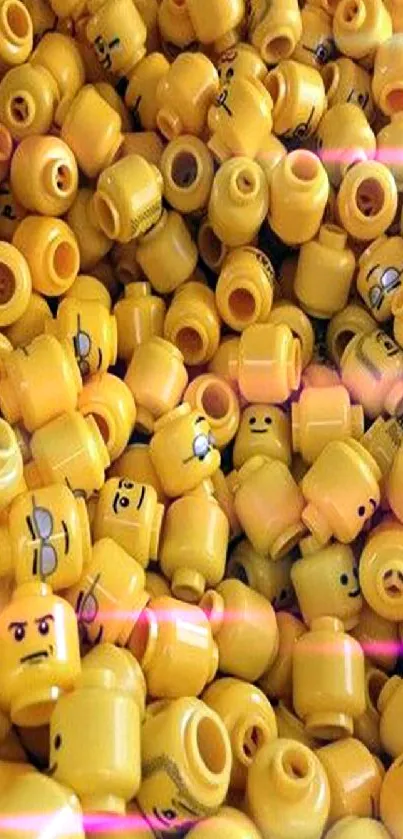 Pile of bright yellow LEGO heads in playful arrangement.