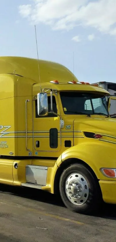 Bright yellow semi-truck under blue sky.