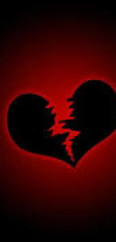 Broken heart with red glow on a dark background wallpaper.