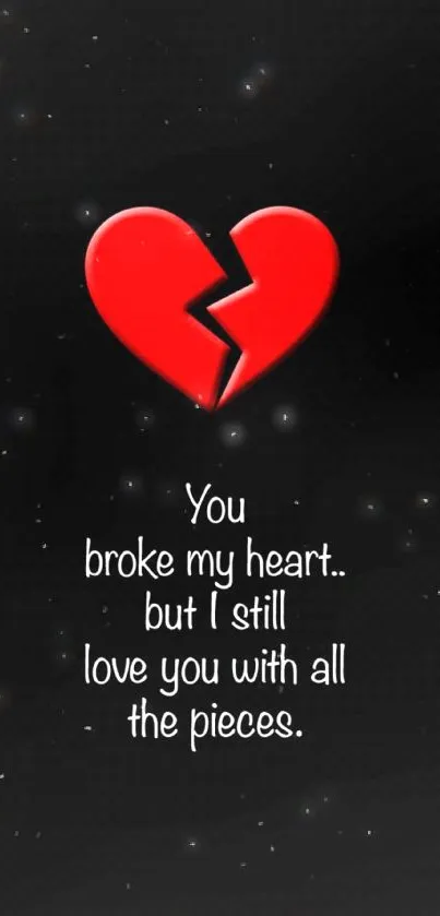 Red broken heart with love quote on black background.