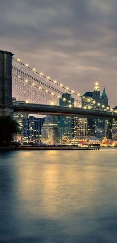 Brooklyn Bridge at night with city lights and reflections on water.