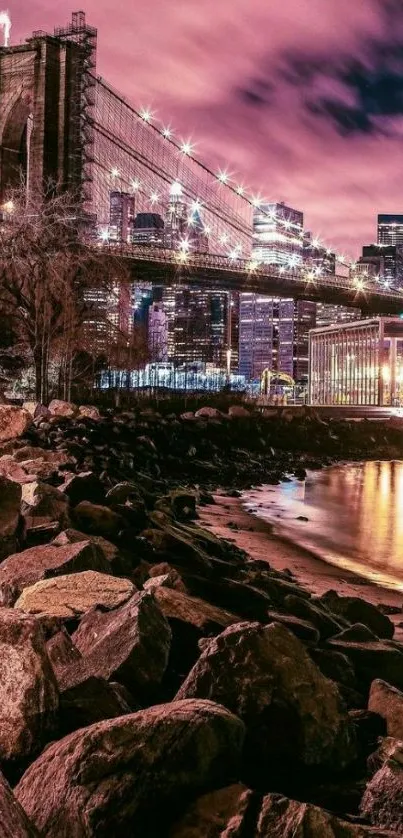 Brooklyn Bridge at night with pink sky and city lights.