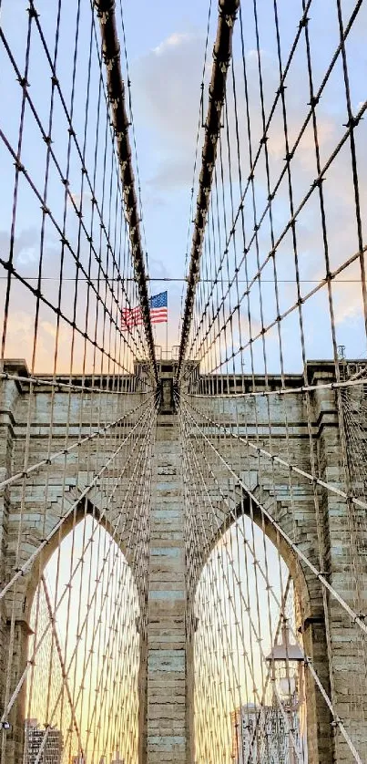 Brooklyn Bridge at sunrise with city skyline in the background.