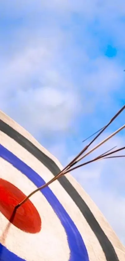 Archery target with arrows against a blue sky.