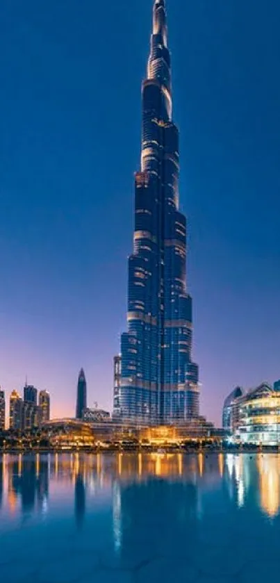 Night view of Burj Khalifa with city skyline and reflections.