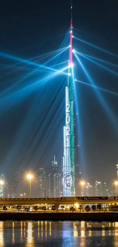 Burj Khalifa illuminated with blue beams at night, reflecting in a calm river.