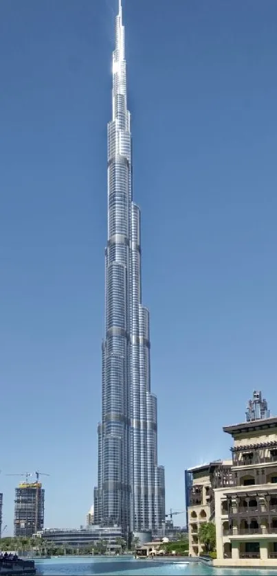 Burj Khalifa against clear blue sky in Dubai skyline.