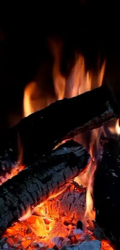 Mobile wallpaper with burning firewood and glowing embers.