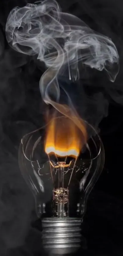 Burning lightbulb emitting smoke on a dark background.