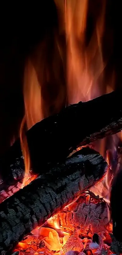 Mobile wallpaper of burning logs with vivid flames and glowing embers.