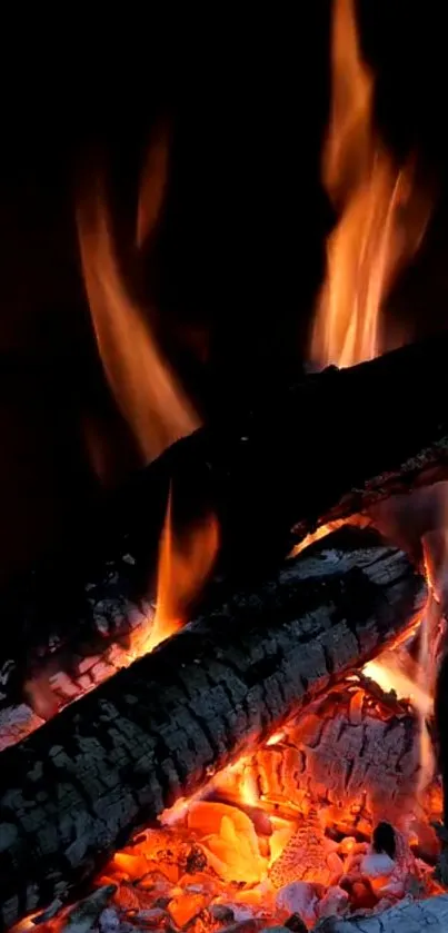 Mobile wallpaper of burning logs with bright orange flames.