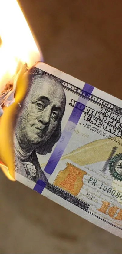 Burning hundred-dollar bill wallpaper with fire and currency themes.