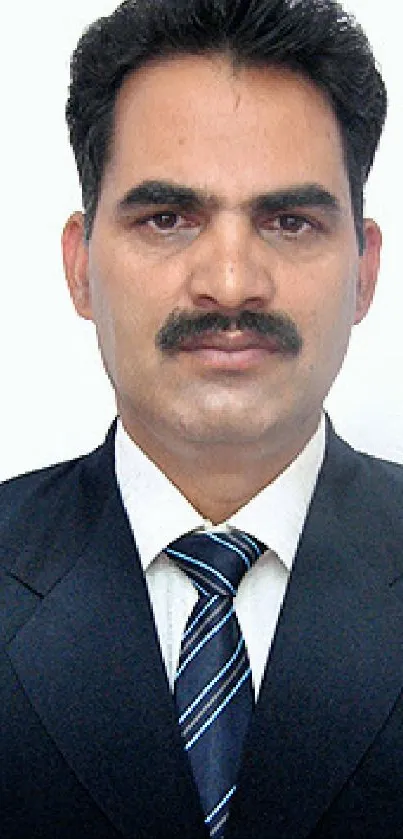 Business portrait of a man in a suit against a white background.