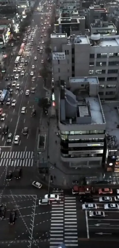 Aerial view of city streets at night with bustling traffic and modern buildings.