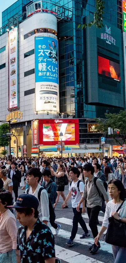 Crowded city street with many pedestrians crossing at dusk.