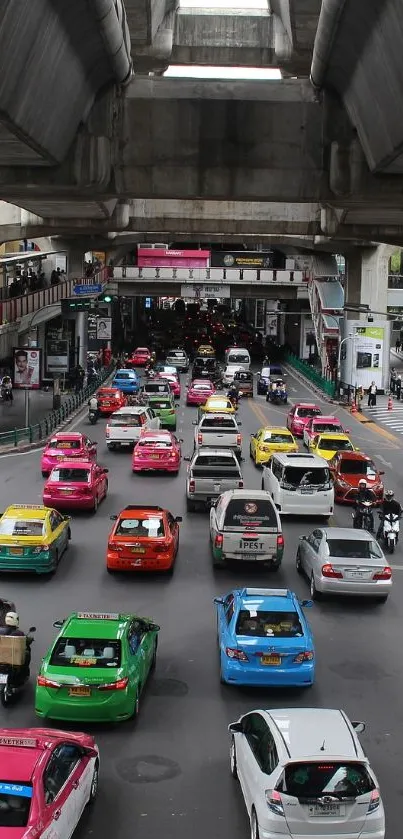 View of city traffic with colorful cars under an overpass.