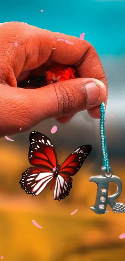 Hand holding charm with butterfly on vibrant background.