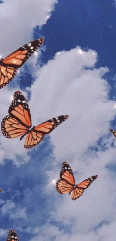 Monarch butterflies fluttering in a blue sky with clouds and sparkles.