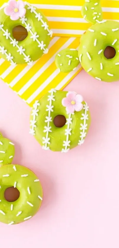 Green cactus-shaped donuts on a pastel pink background.