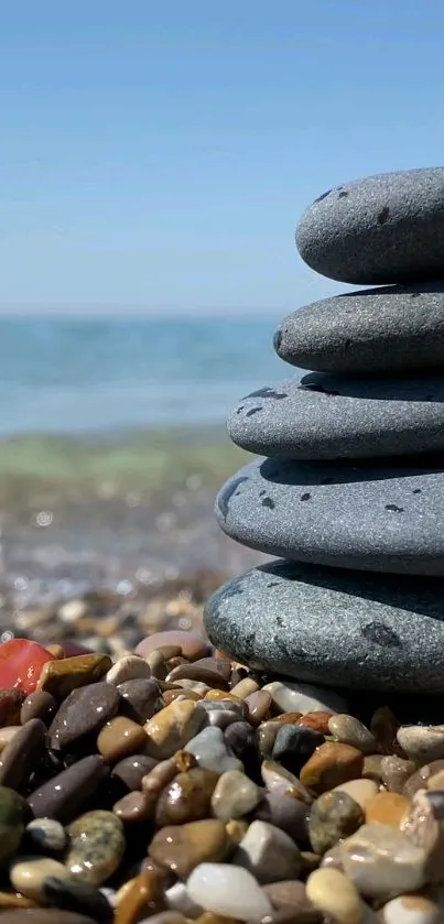 Stacked beach stones with calming sea view and blue sky background.