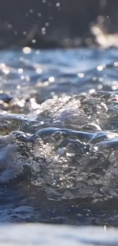 Close-up of flowing water with sunlight reflecting on the surface.