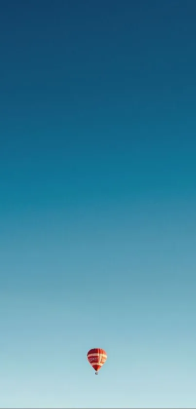 A hot air balloon floats in a clear blue sky.