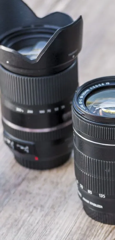 Close-up view of camera lenses on wooden surface.