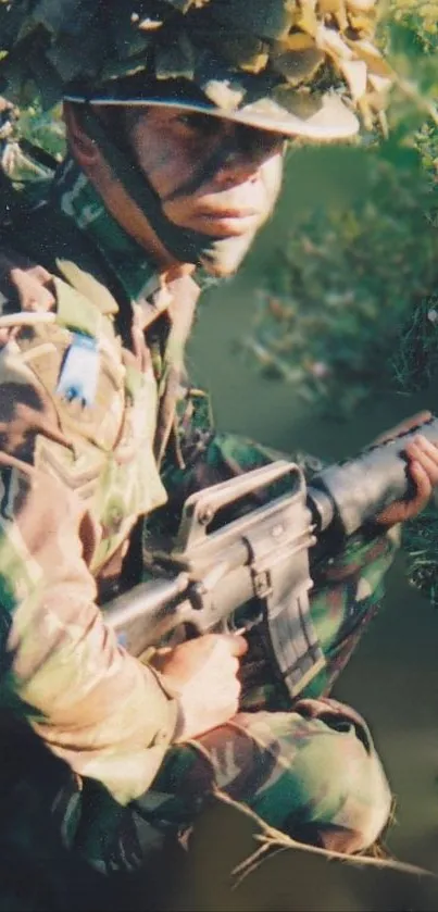 Soldier in camouflage holding a rifle outdoors.