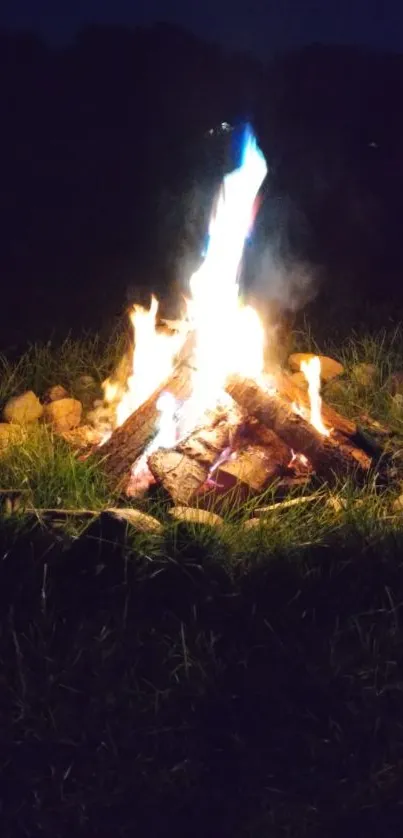 Glowing campfire at night with vibrant flames.