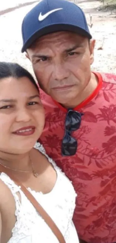 A couple enjoys a serene moment on a tropical beach.