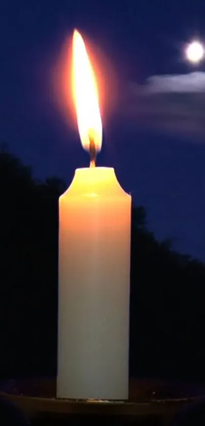 Candle glowing with a bright flame under a serene moonlit sky.