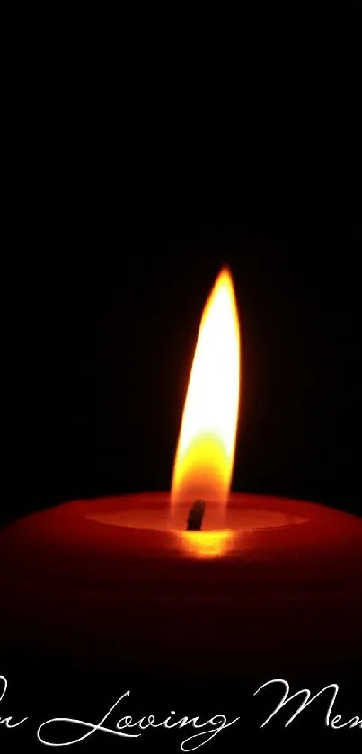 Candle flame in loving memory wallpaper with a peaceful black background.