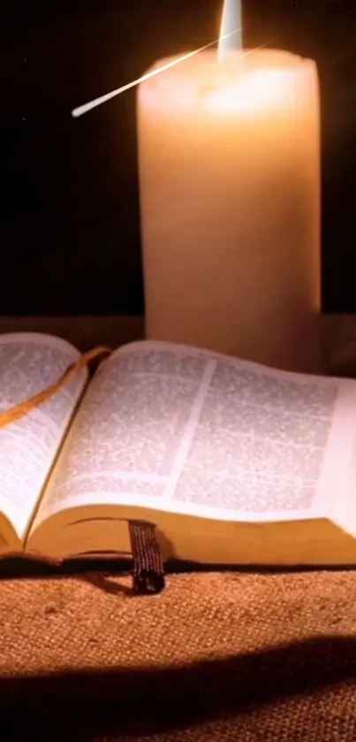 Open book with candlelight on a cozy textile.