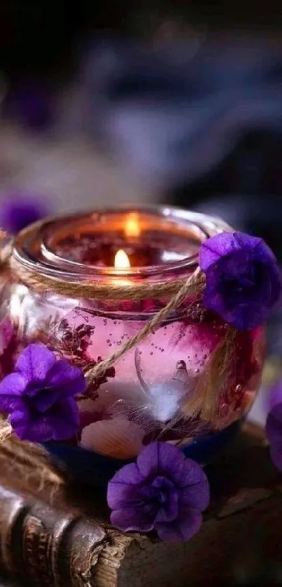 Candlelit jar with purple flowers creating a cozy ambiance.