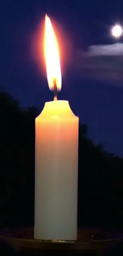 A glowing candle in a dark night with a moonlit sky above.