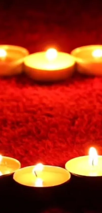 Mobile wallpaper with glowing candles on a red background for a warm ambiance.