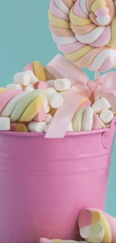 Colorful marshmallows in a pink bucket with a pastel background.