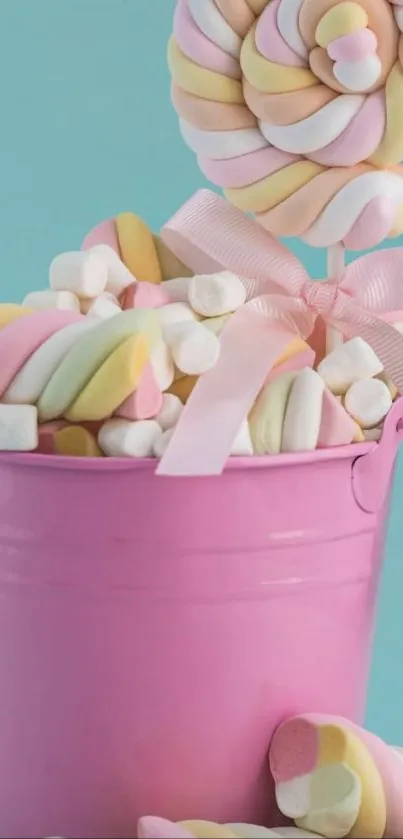 Colorful candy in pink bucket with marshmallows.