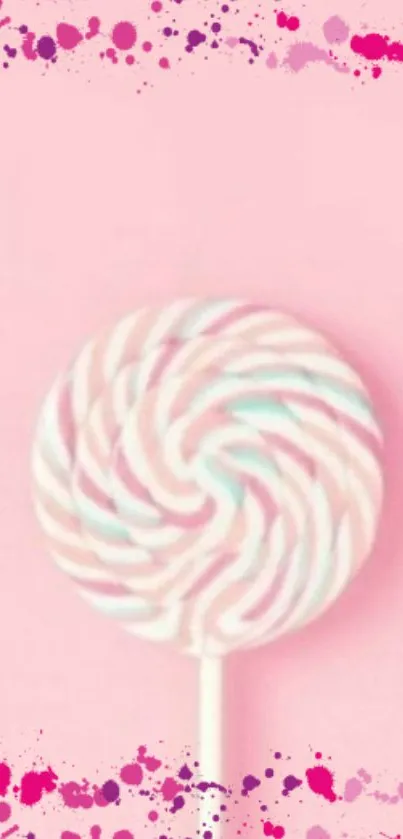 Pink lollipop on a soft pink background with colorful splashes.